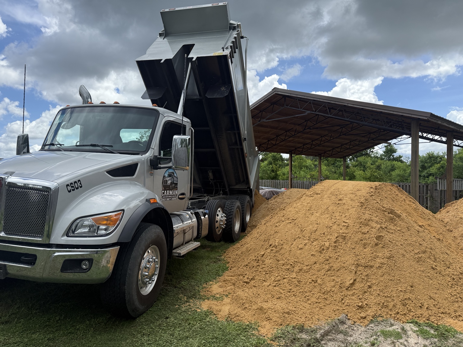 Dump truck delivering sand
